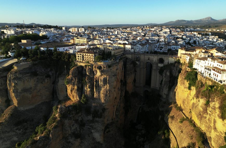 A stunning aerial view of El Tajo Gorge and Ronda's cityscape in Spain at daytime.